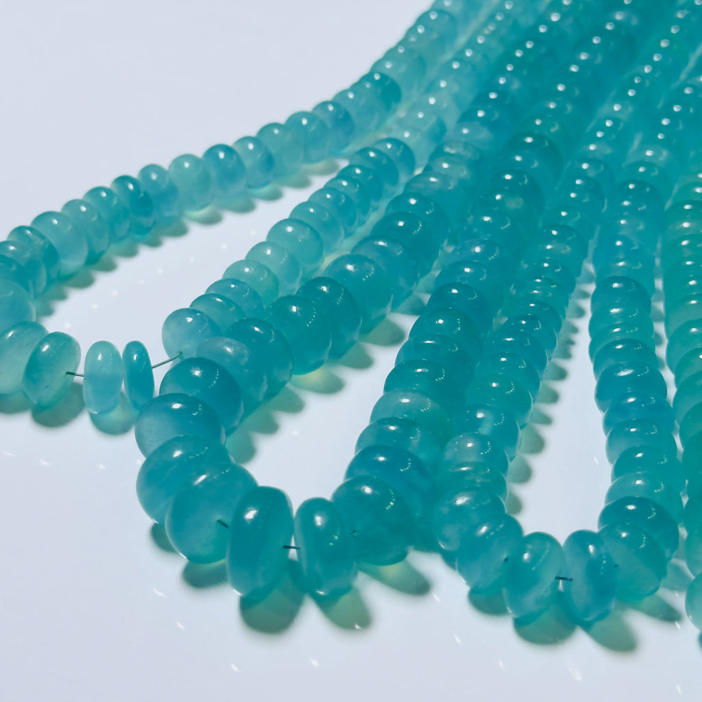 Turquoise glass beads on a white background