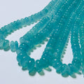 Turquoise glass beads on a white background