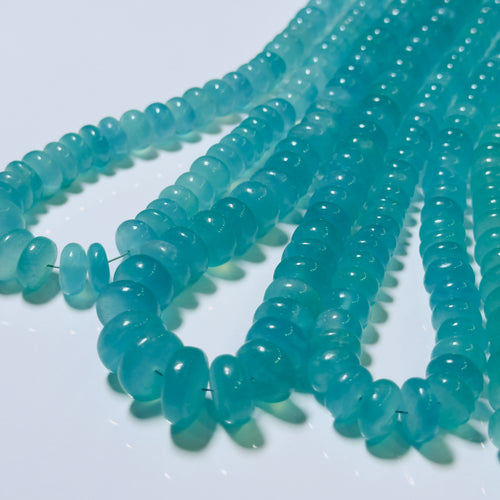 Turquoise glass beads on a white background