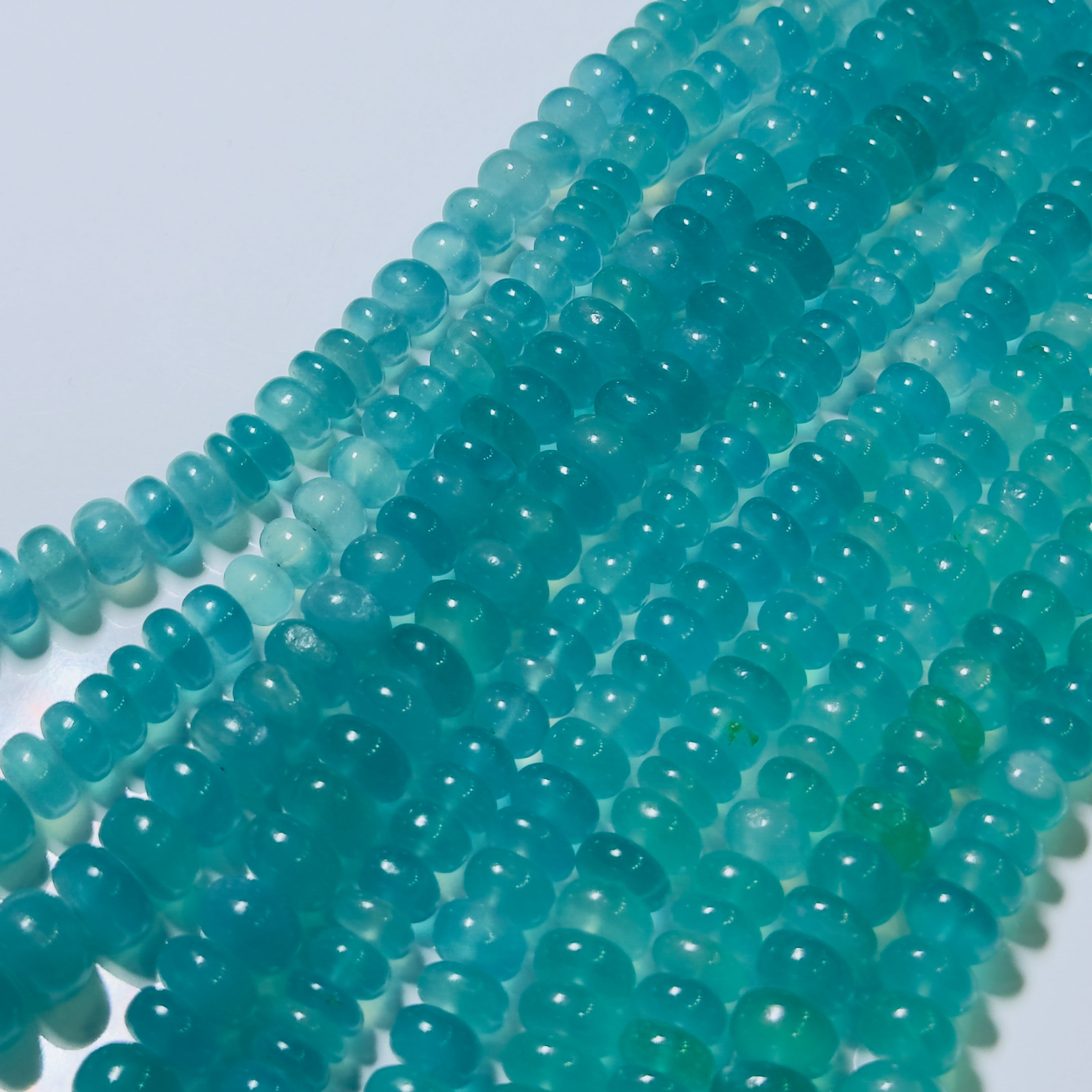 Close-up of turquoise beads on a white background