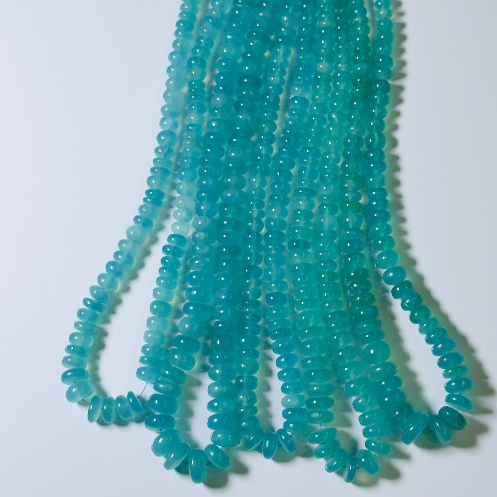 Turquoise glass beads on a white background