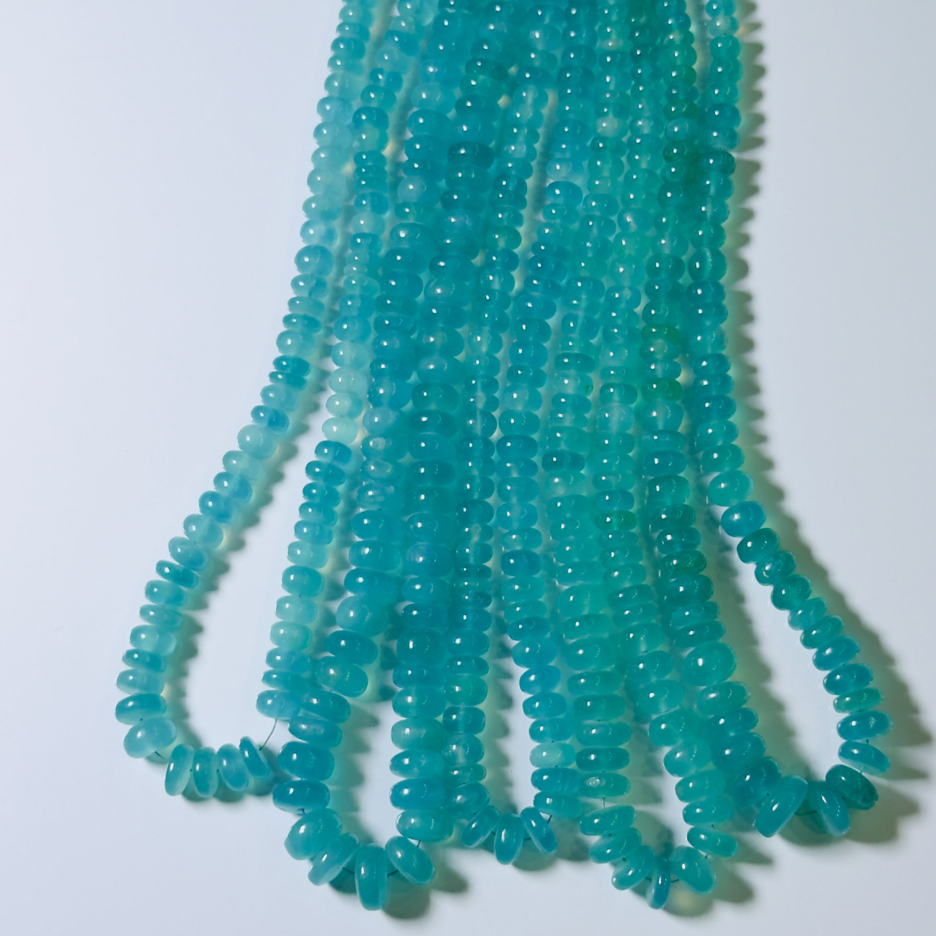 Turquoise glass beads on a white background