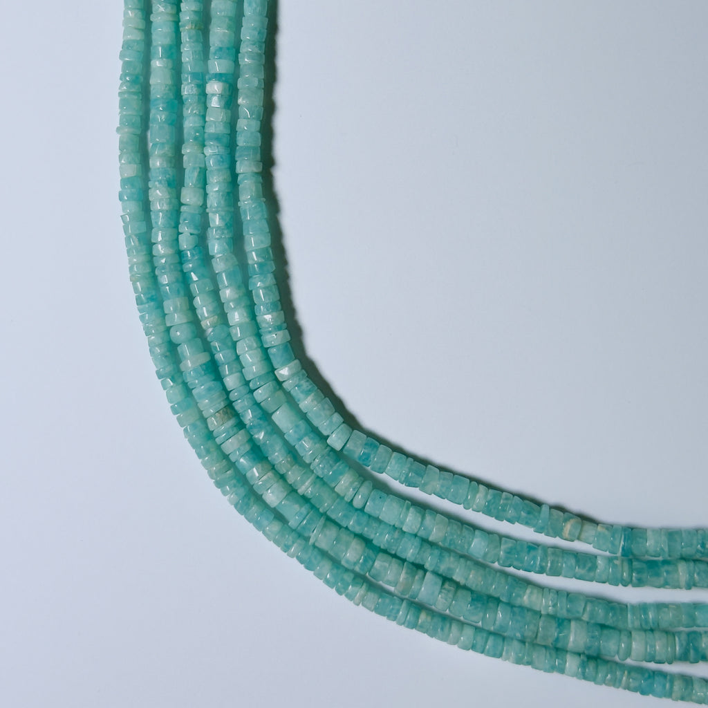 Turquoise bead necklace on a light gray background