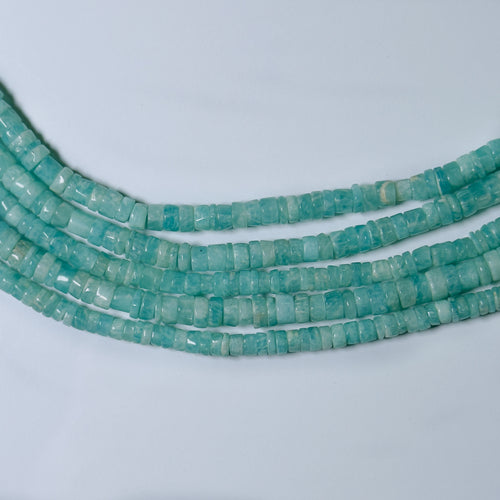 Turquoise bead necklace on a light gray background