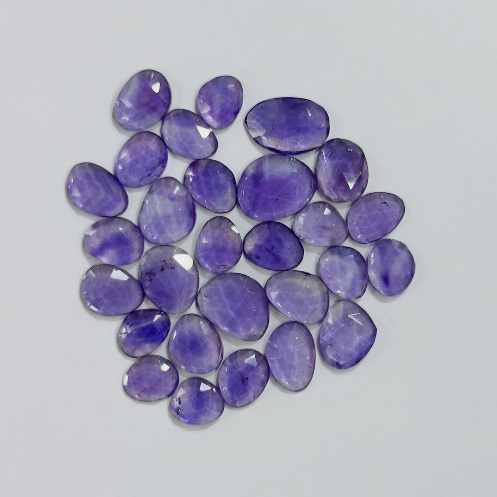 Purple gemstones on a light gray background