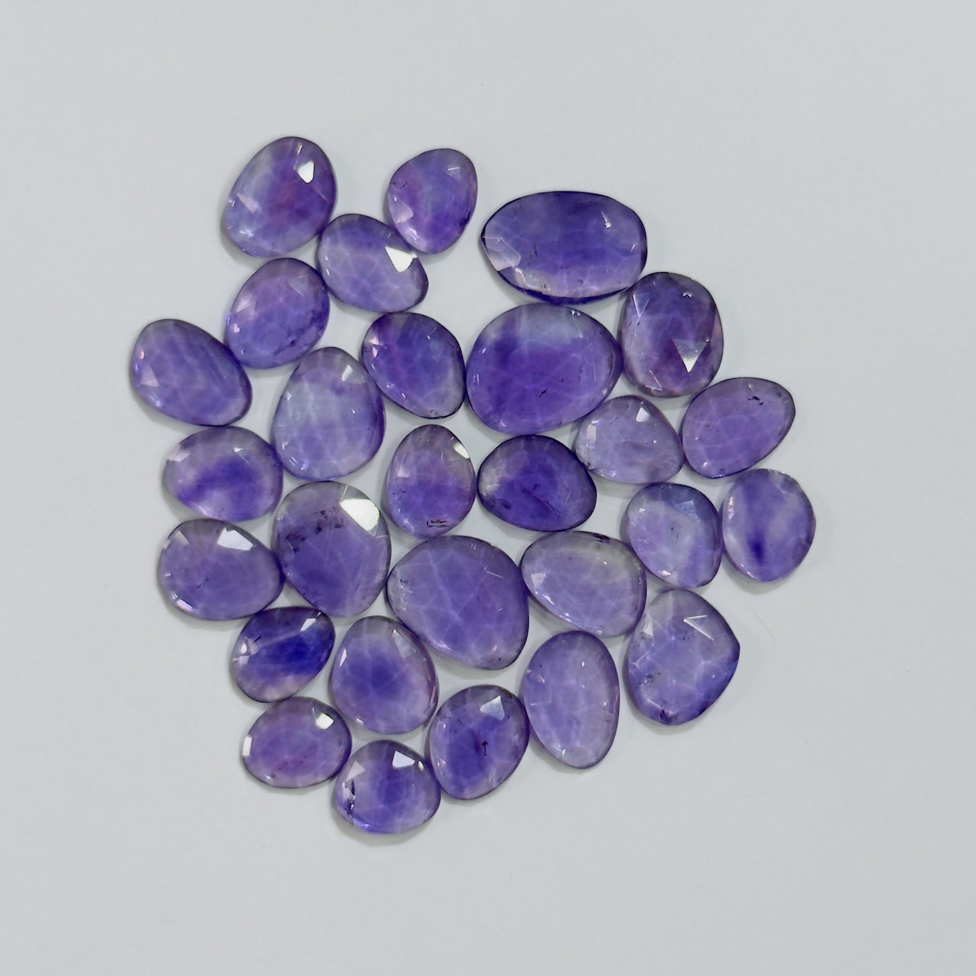 Purple gemstones on a light gray background