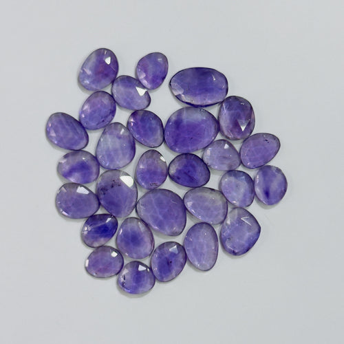Purple gemstones on a light gray background