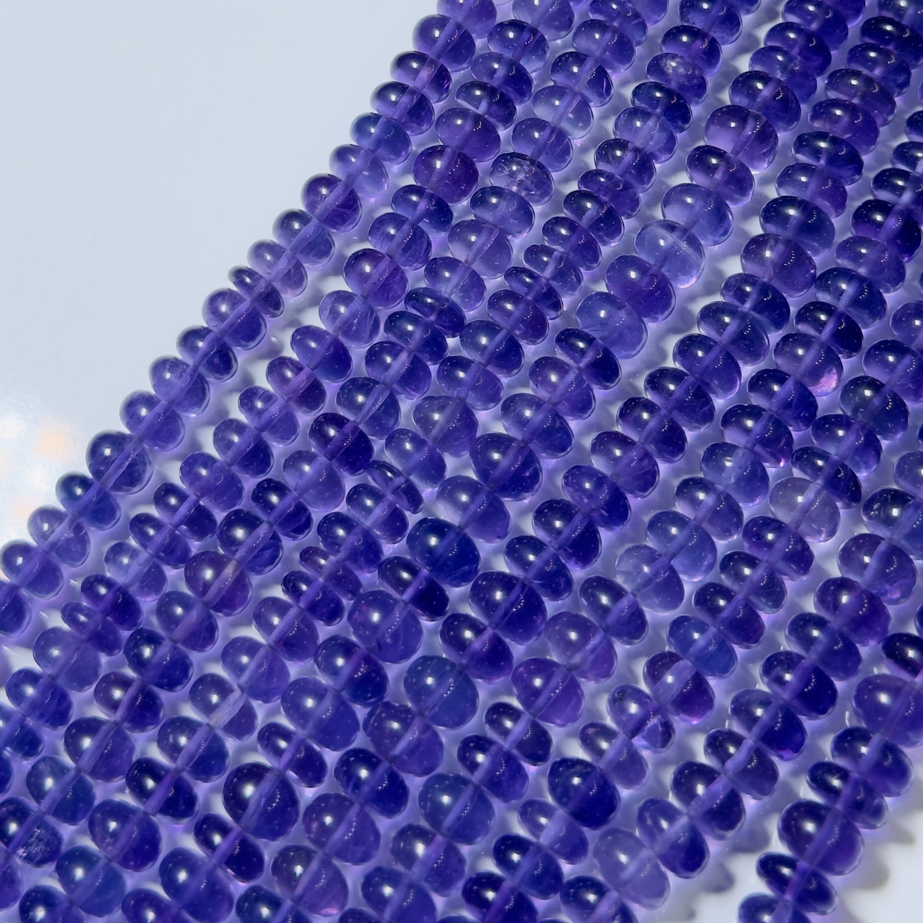 Close-up of purple beads on a white background