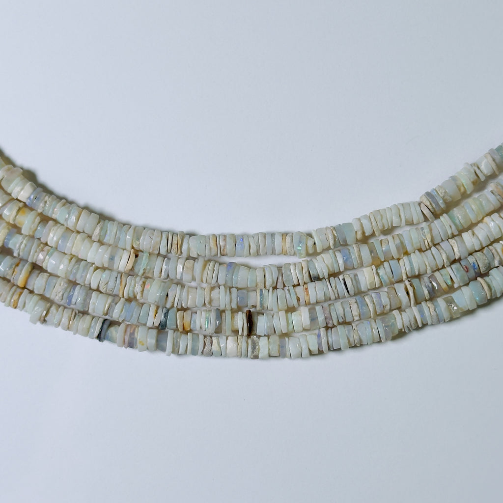 Necklace with heishi beads on a light gray background