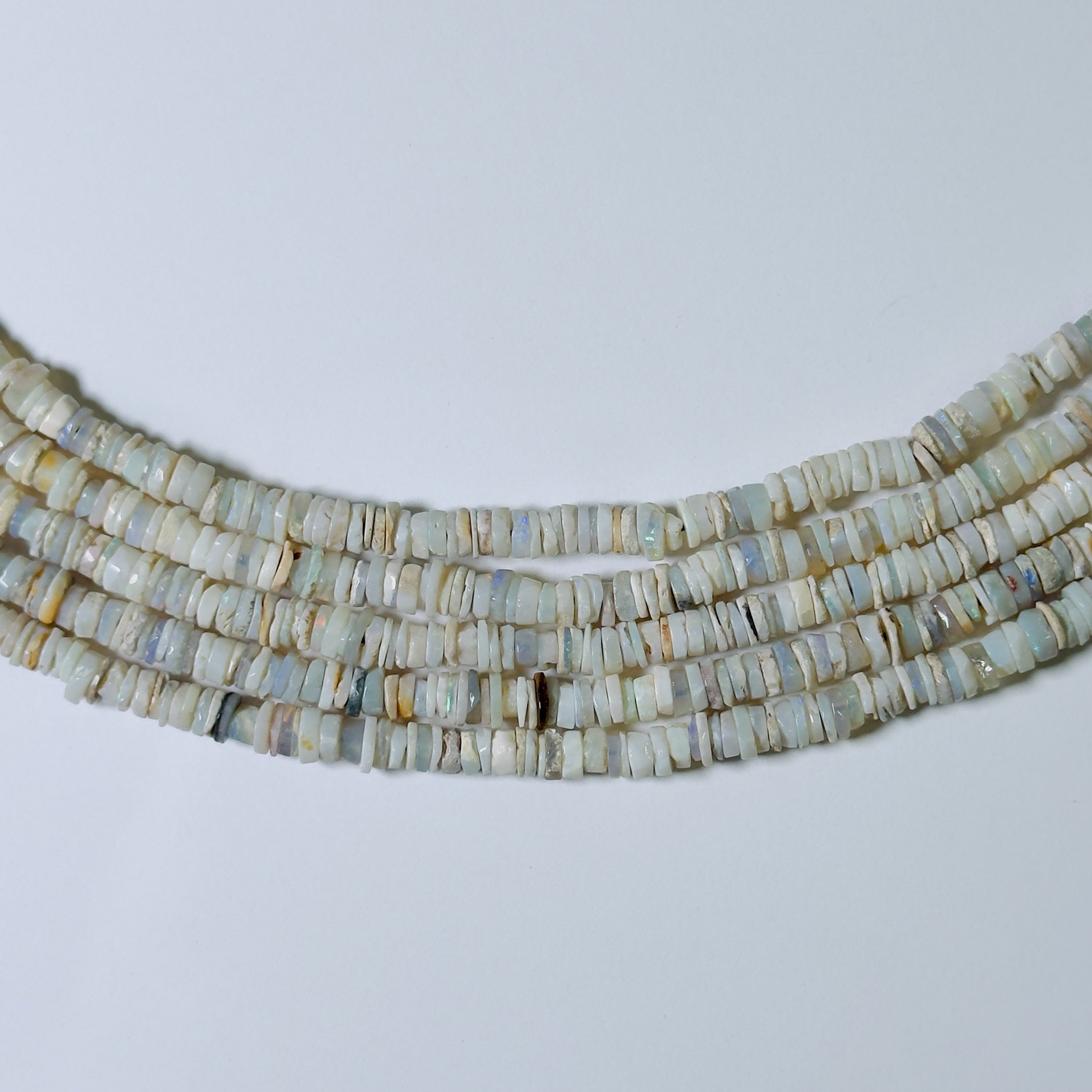 Necklace with heishi beads on a light gray background