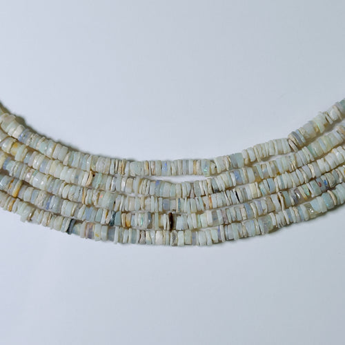 Necklace with heishi beads on a light gray background