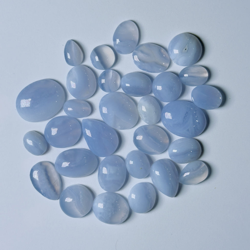 Collection of light blue stones on a light gray background