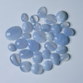 Collection of light blue stones on a light gray background