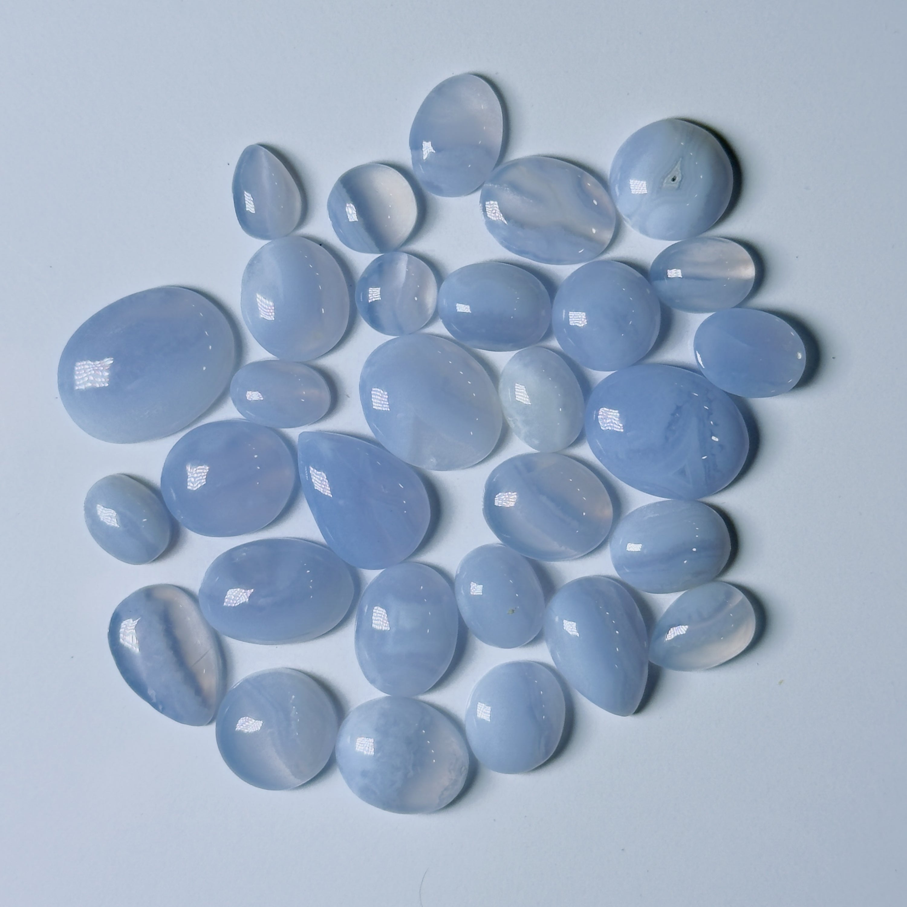 Collection of light blue stones on a light gray background