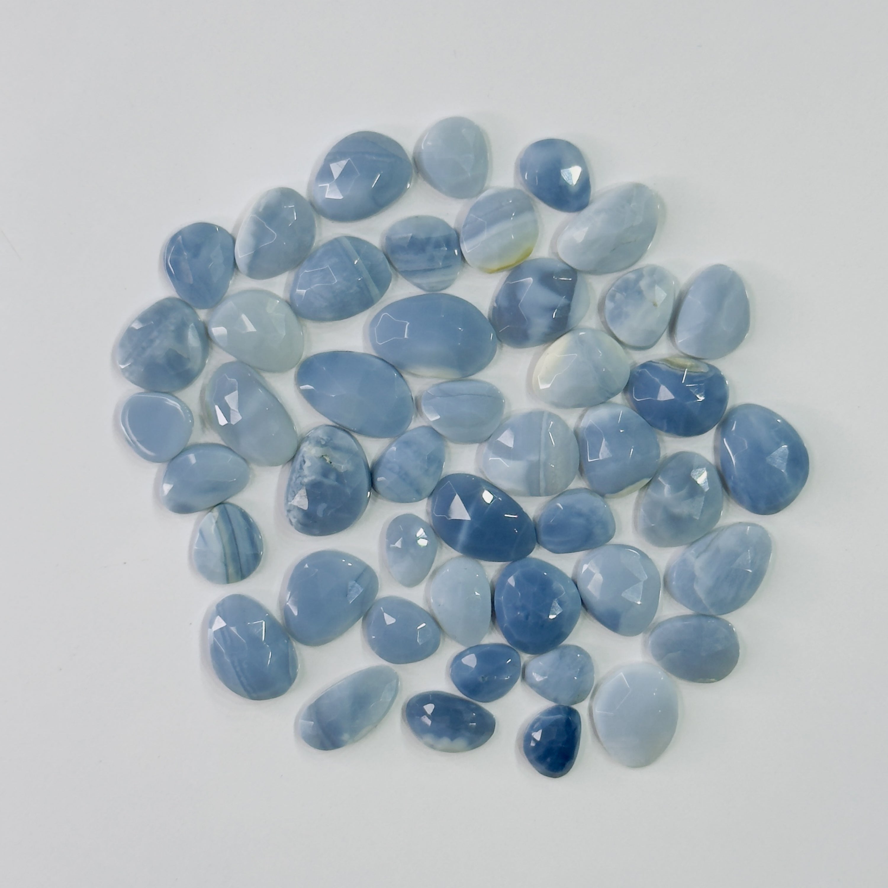 Collection of blue stones on a white background
