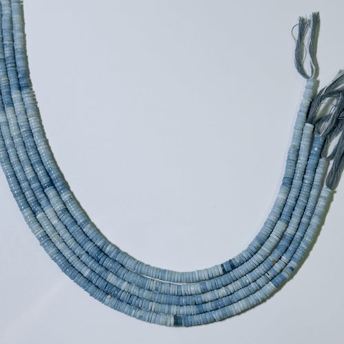 Blue beaded necklace on a light gray background