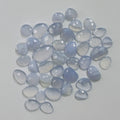 Collection of blue chalcedony stones on a light gray background