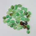 Collection of green gemstones on a white background