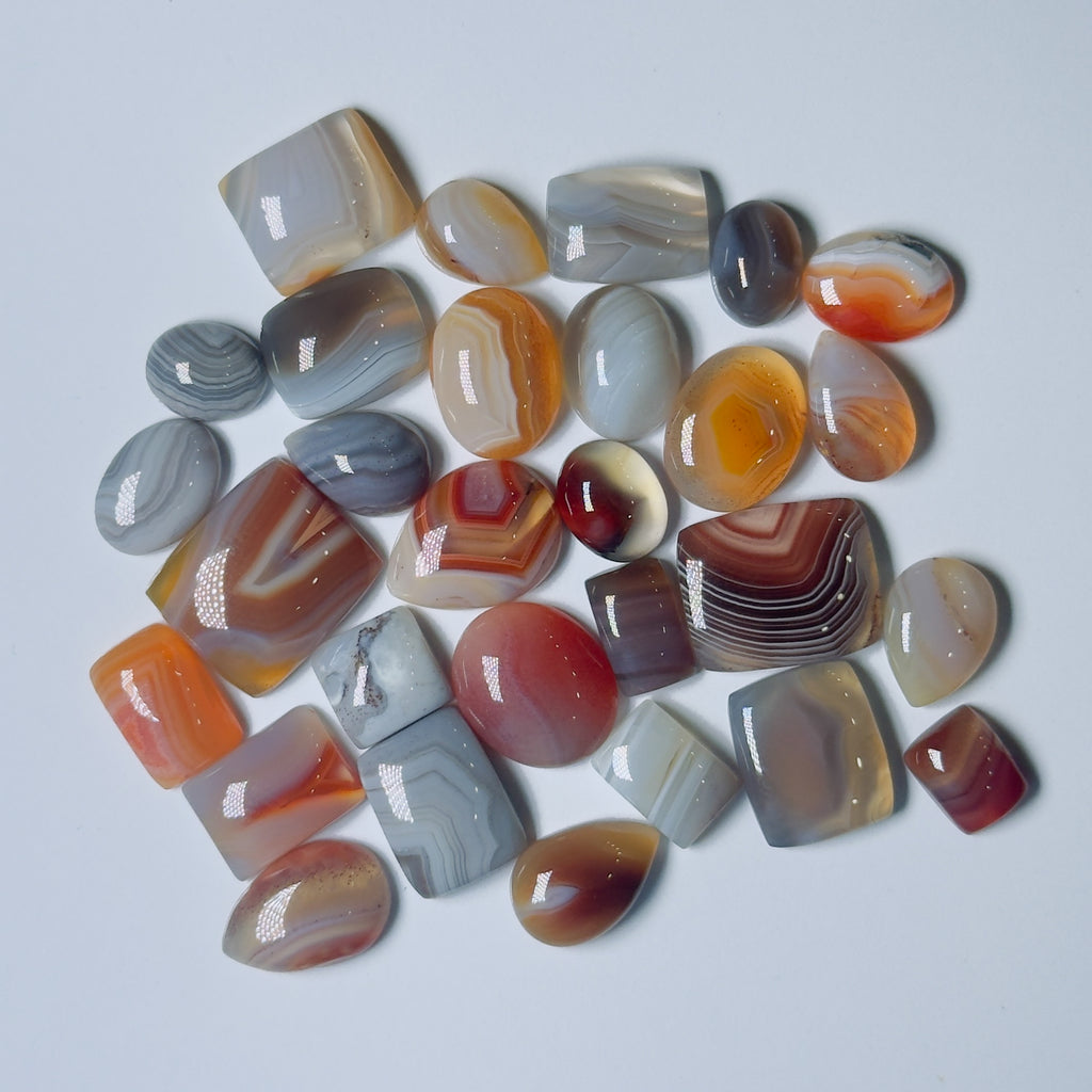 Collection of multicolored agate stones on a White background