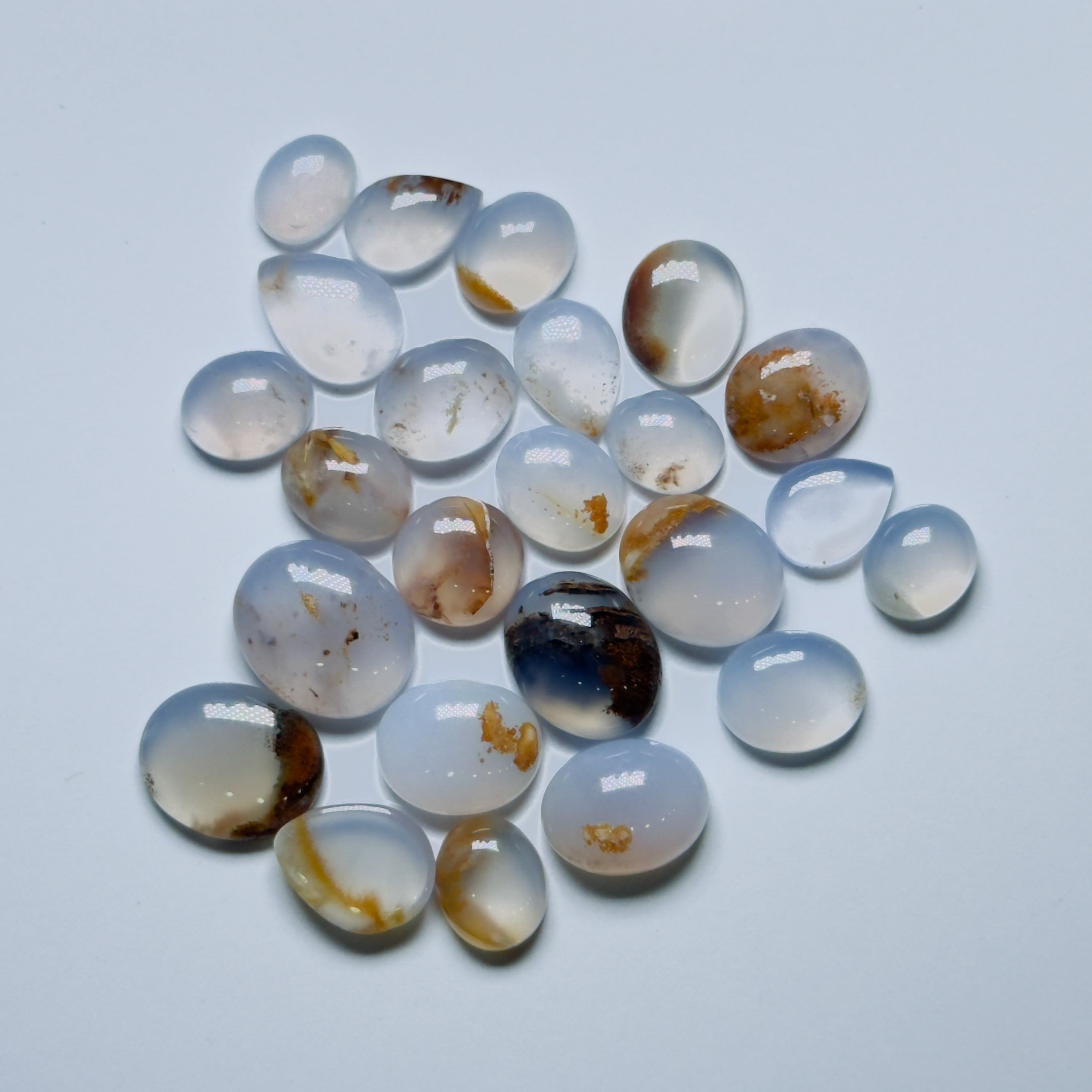 Collection of teardrop-shaped agate stones on aWhite background