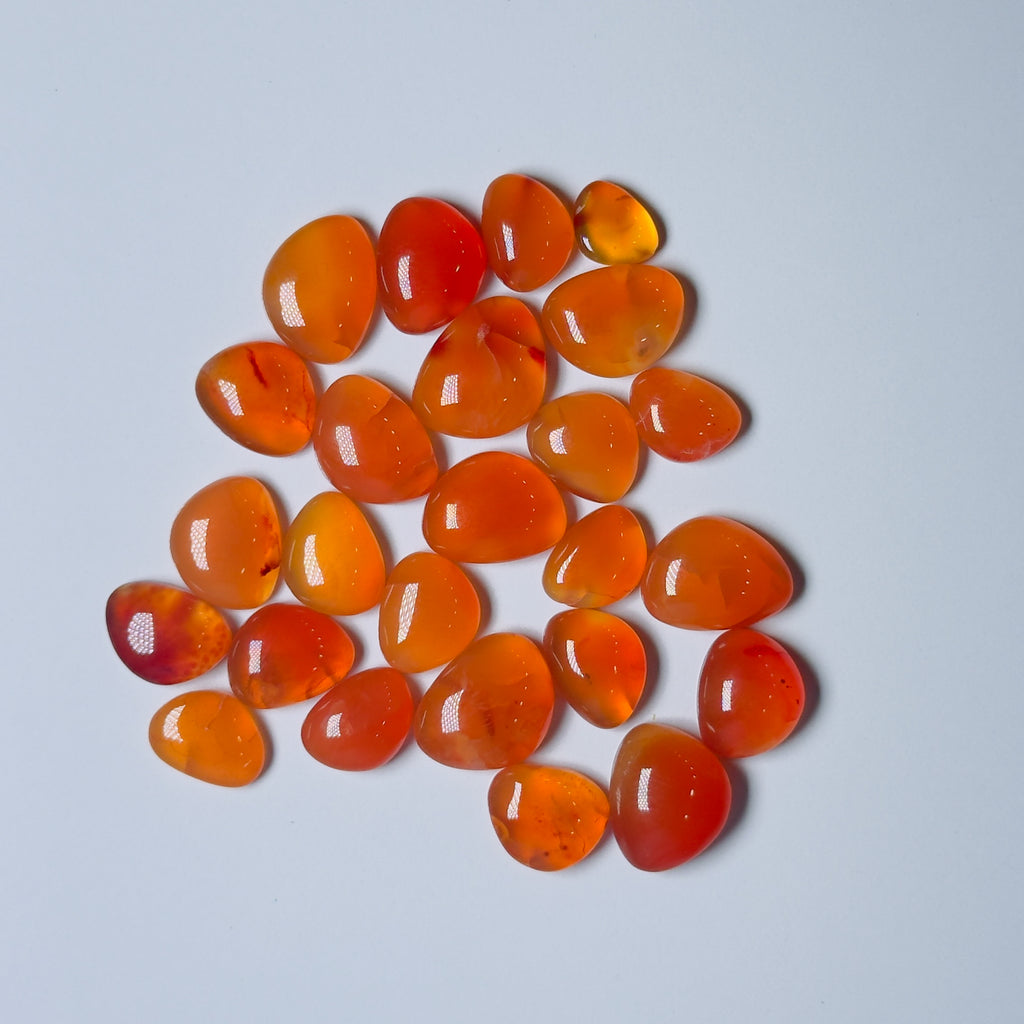 Collection of orange-red stones on a White background