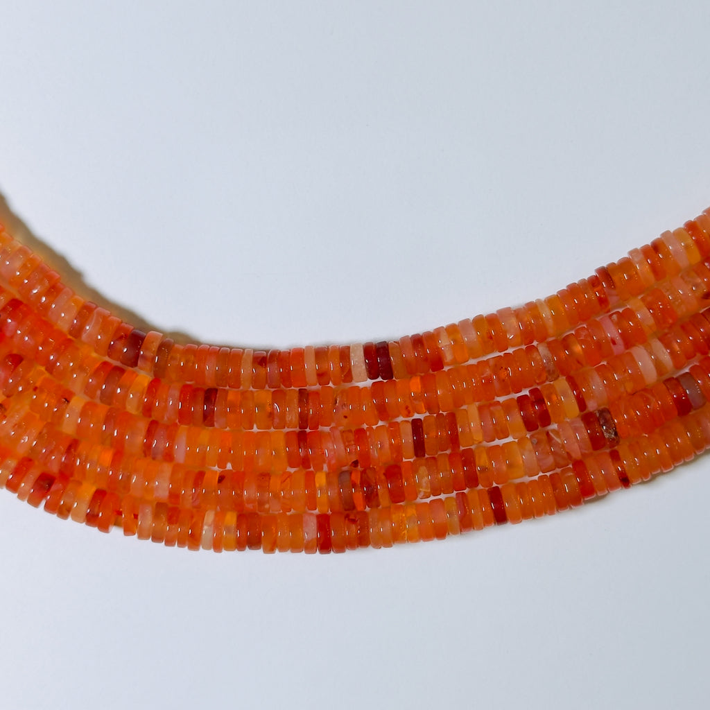 Close-up of a necklace with orange beads on a white background
