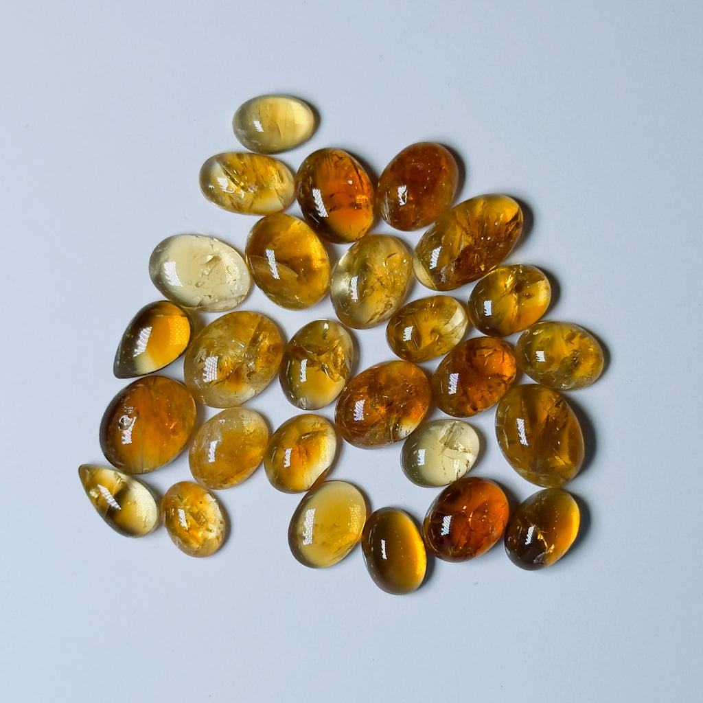 Collection of amber-colored stones on a White background