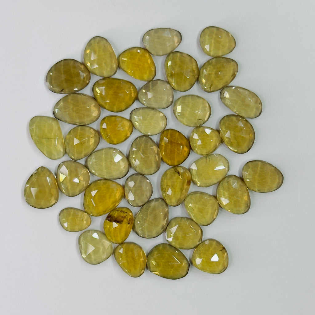 Collection of yellow gemstones on a white background