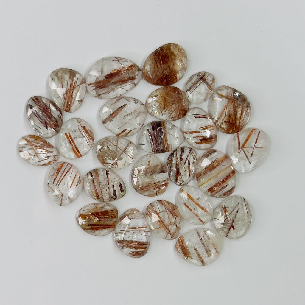 Collection of brown and clear gemstones on a white background
