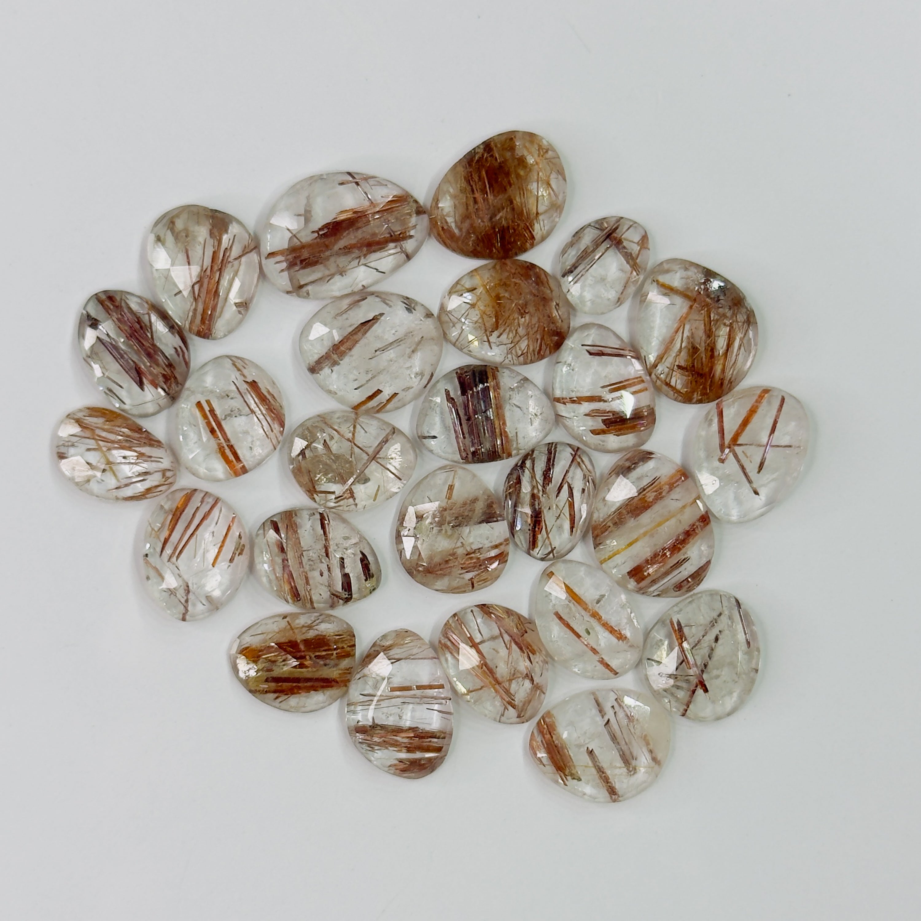 Collection of brown and clear gemstones on a white background