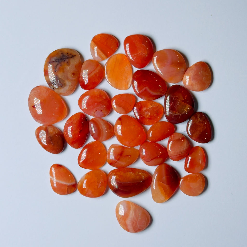Collection of orange and red stones on a White background