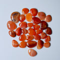 Collection of orange and red stones on a White background