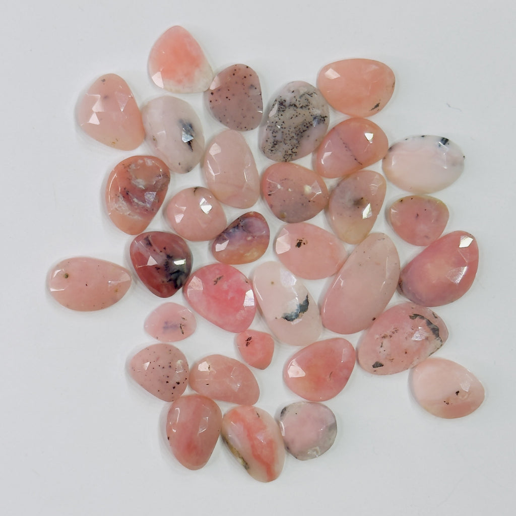 Collection of pink and red pebbles on a white background