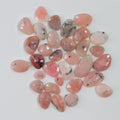 Collection of pink and red pebbles on a white background