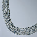 Necklace with small, multicolored beads on a light gray background
