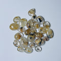 Collection of teardrop-shaped gemstones on a light gray background