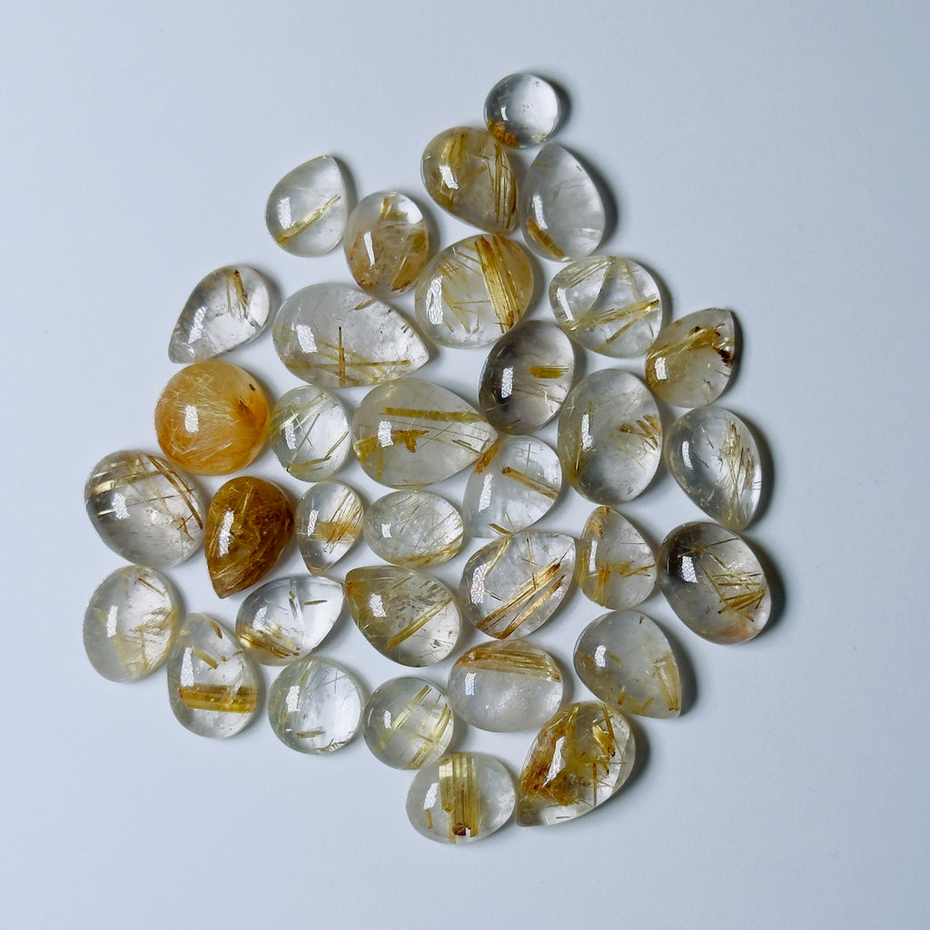 Collection of clear and amber-colored gemstones on a White background