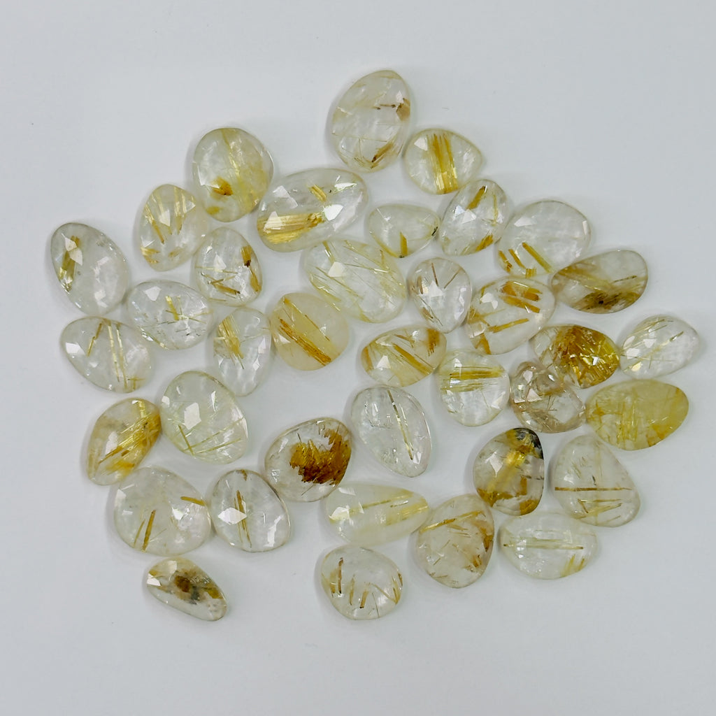 Collection of transparent stones with gold inclusions on a white background