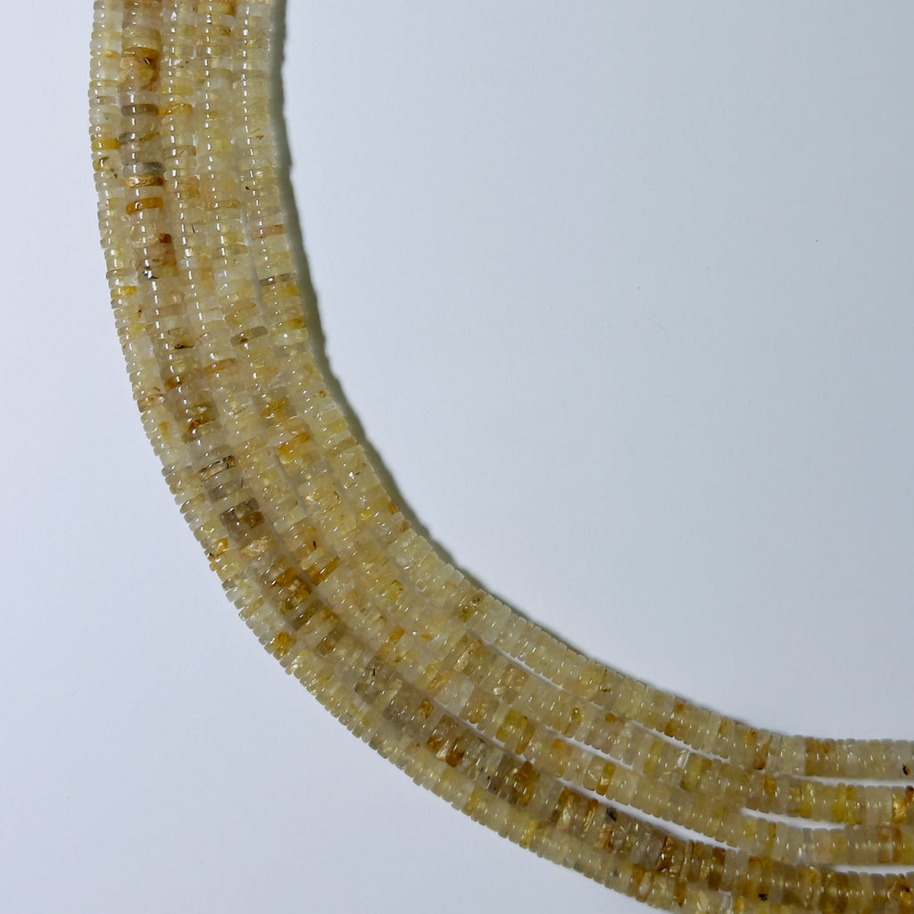 Close-up of a beaded necklace on a light gray background