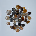 Collection of brown and gray stones on a light blue background