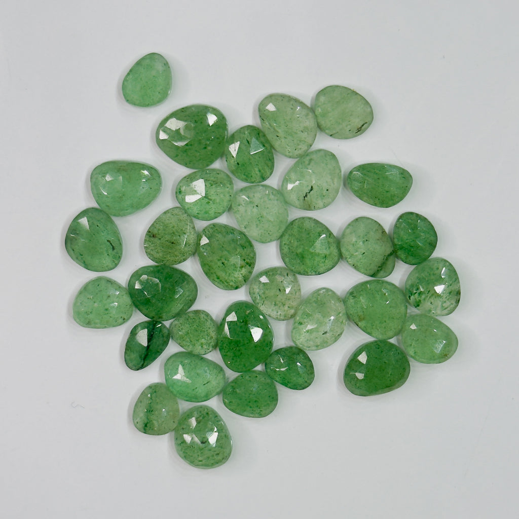 Green gemstones on a light gray background