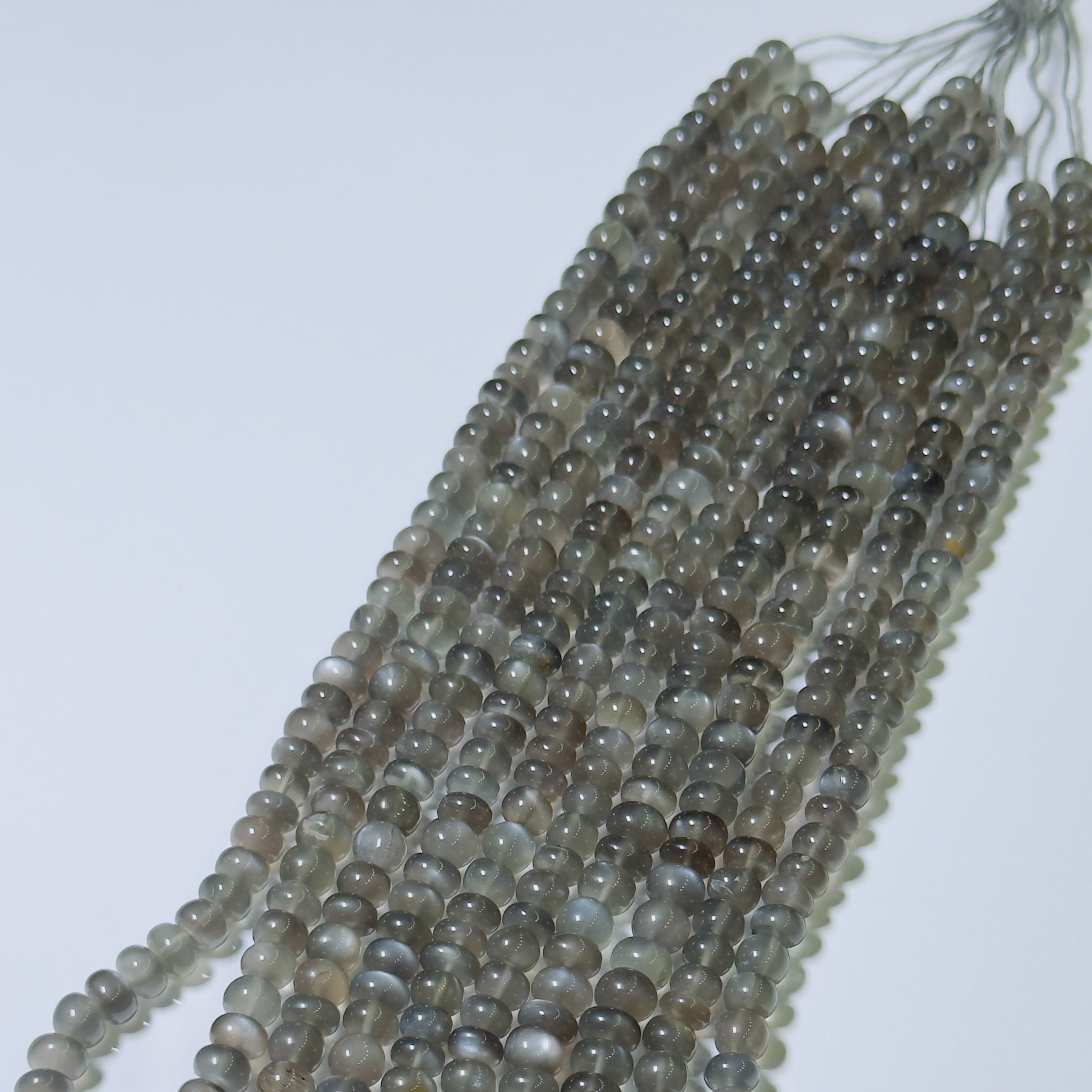 String of gray beads on a white background