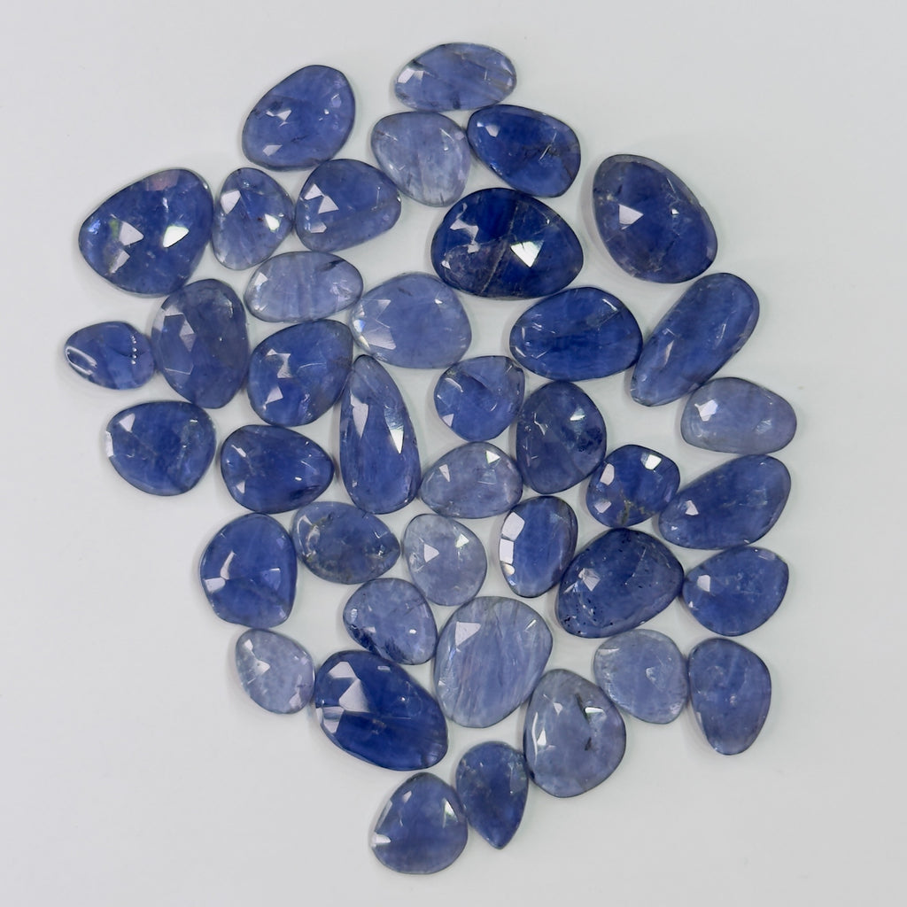 Collection of blue gemstones on a light gray background