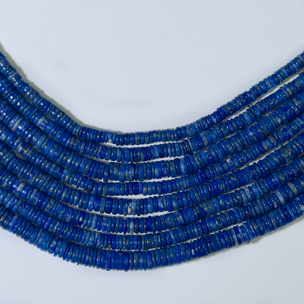 Multiple strands of blue beads on a white background