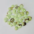 Collection of green turquoise stones on a light gray background