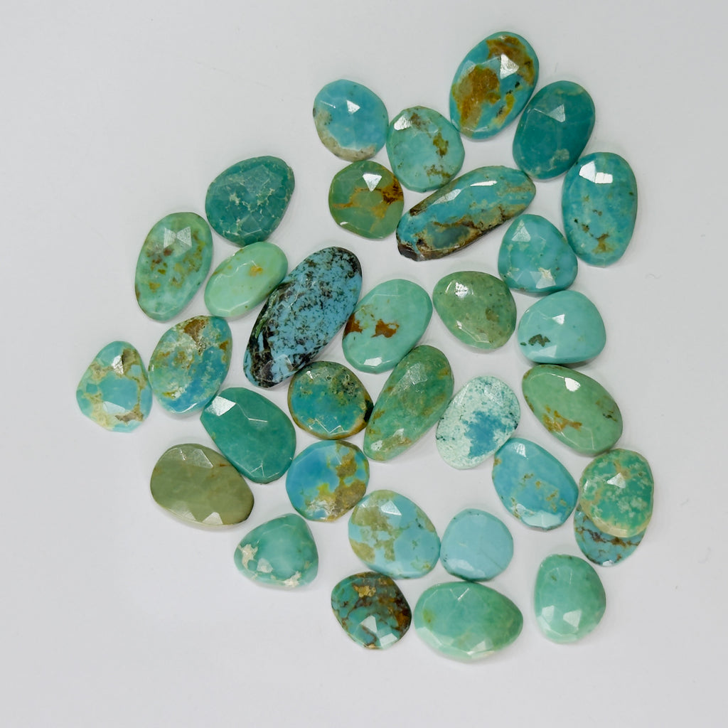 Collection of turquoise stones on a light gray background