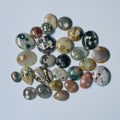 Collection of marbled stones on a light gray background