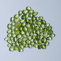 Green teardrop-shaped gemstones on a white background