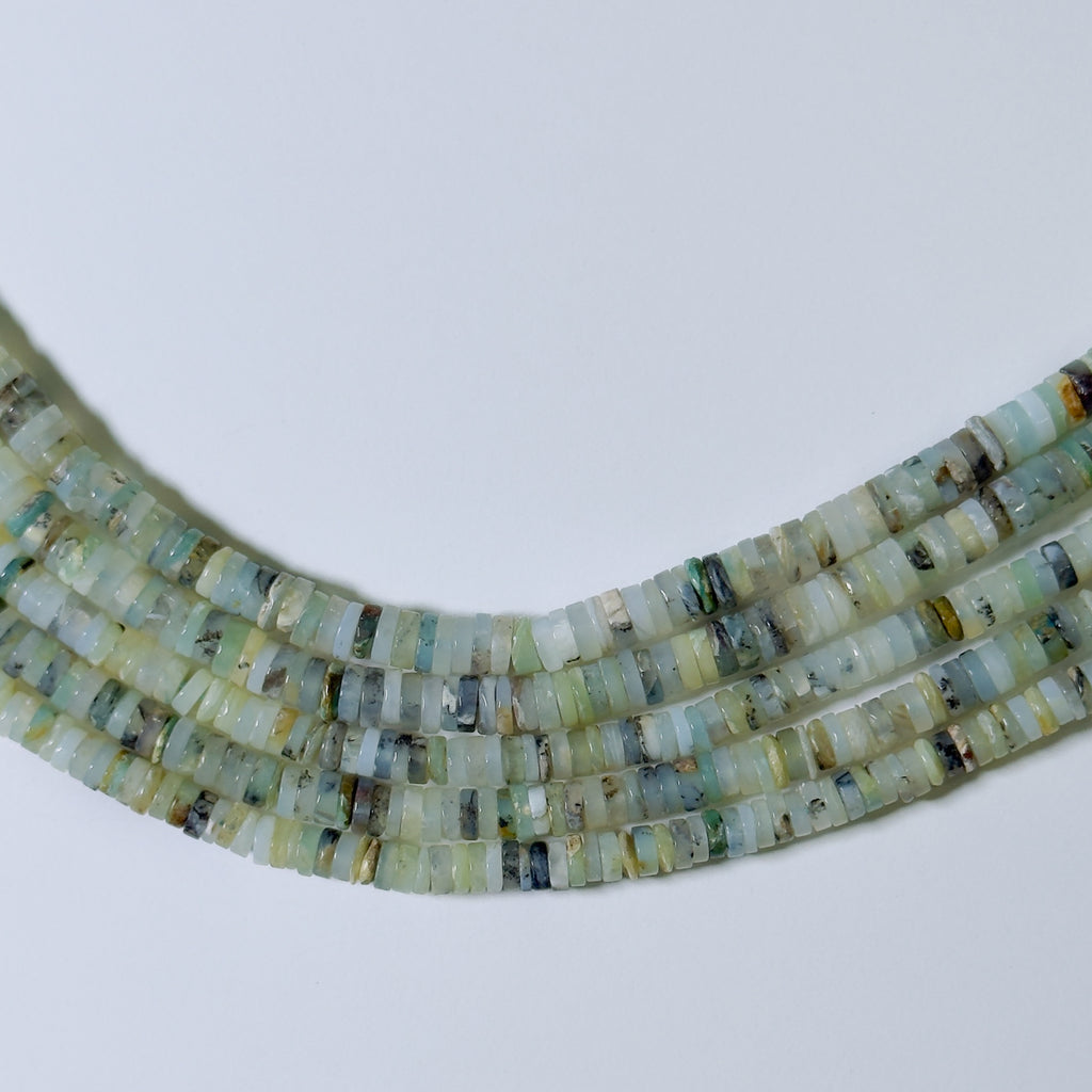Necklace with small, multicolored beads on a light gray background