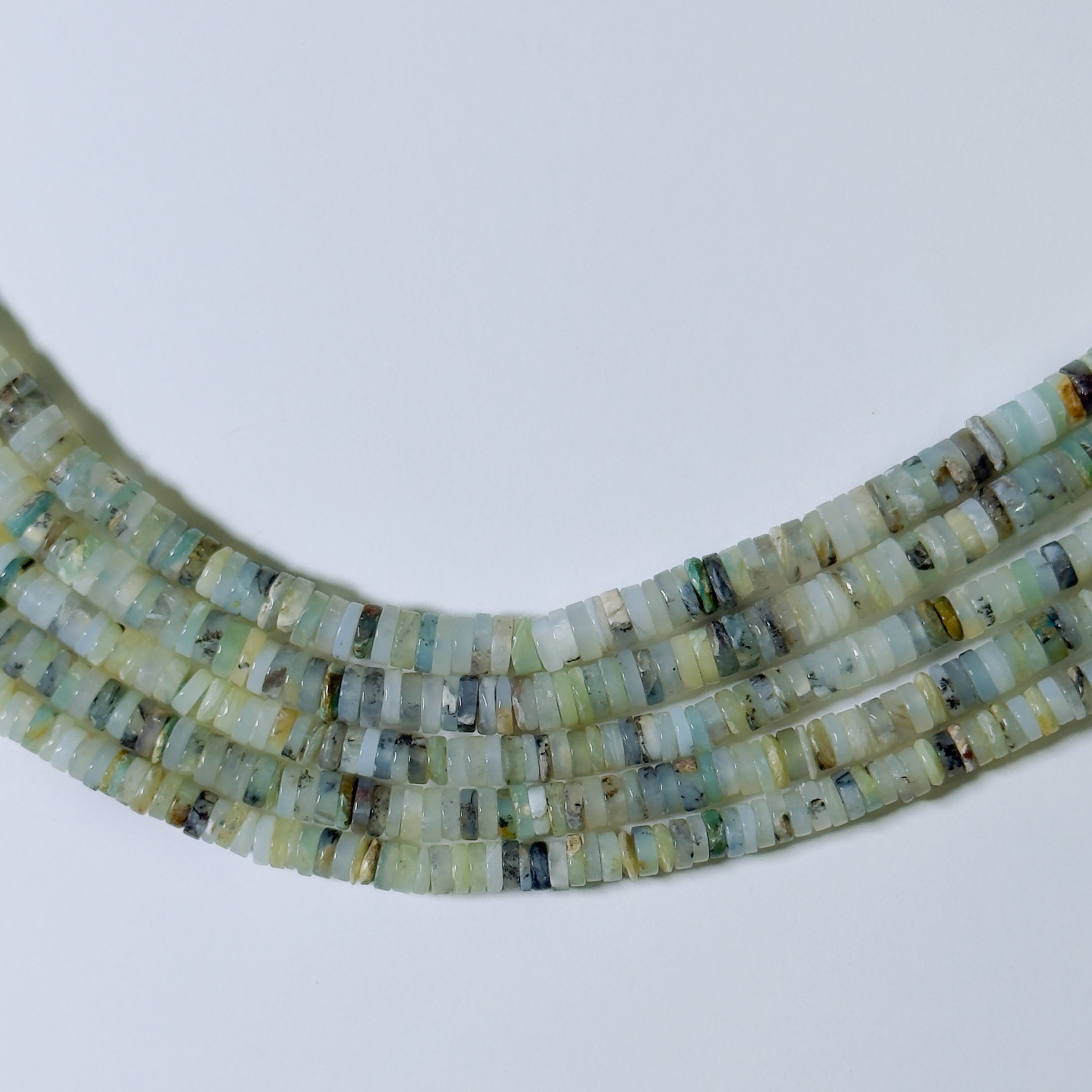 Necklace with small, multicolored beads on a light gray background